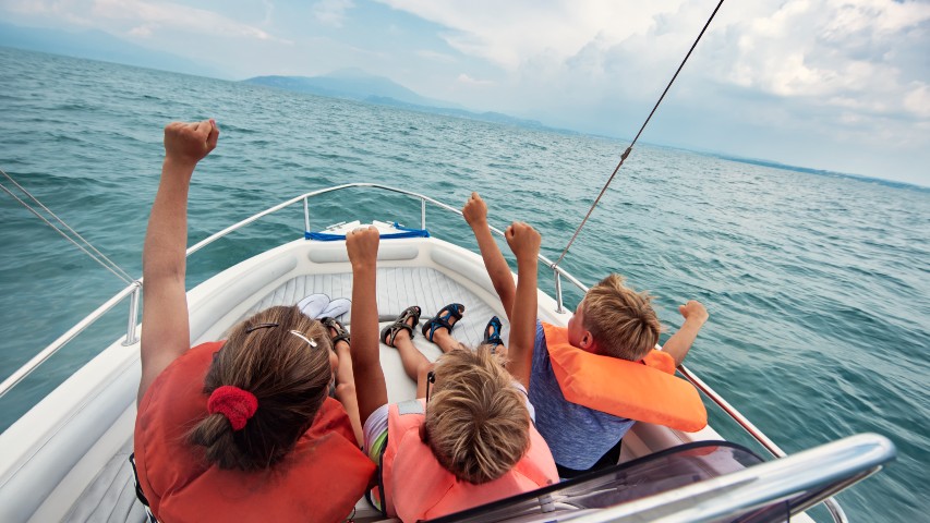 family on a boat in a lake boat loans near syracuse, ny from secny fcu