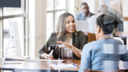 business loan rates near syracuse ny image of client speaking with business loan representative