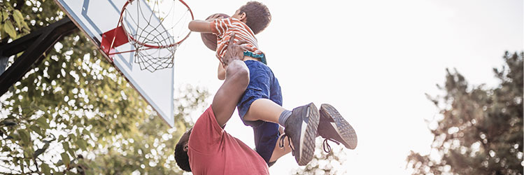 score big with secny father picking son up to dunk basketball