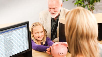 savings accounts for kids near syracuse ny panel image of a young girl handing over her piggy bank to sign up for a savings account