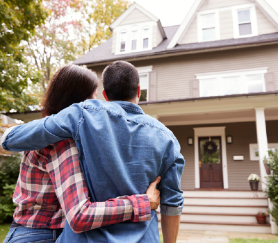 first time home buyer loan near syracuse ny couple standing in front of home