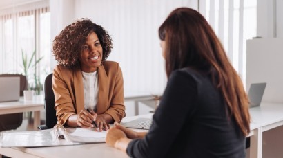 medical perks near syracuse ny panel image of woman speaking with client about medical benefits from secny fcu