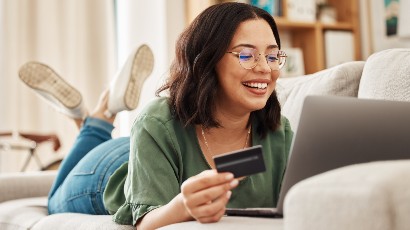 credit cards near syracuse ny panel image of a woman using her credit card smiling at her computer