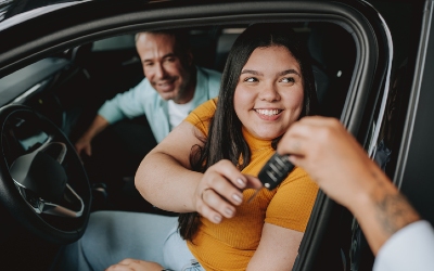 auto loan rates near syracuse ny woman receiving car key