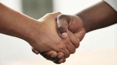 business banking benefits near syracuse ny panel image of two businessman shaking hands at secny fcu