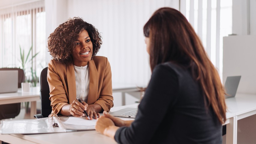 medical perks near syracuse ny image of woman speaking with client about medical benefits with secny fcu