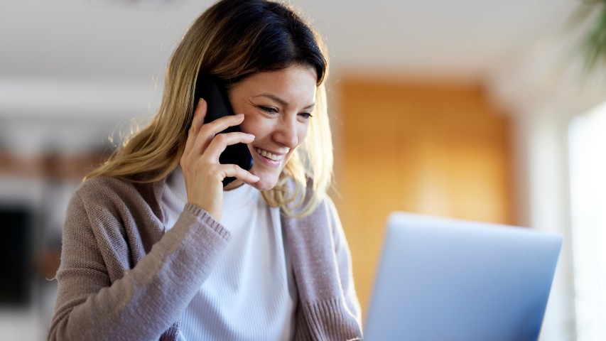 mortgage deparment survey near syracuse ny image of woman talking on cellphone while working on laptop