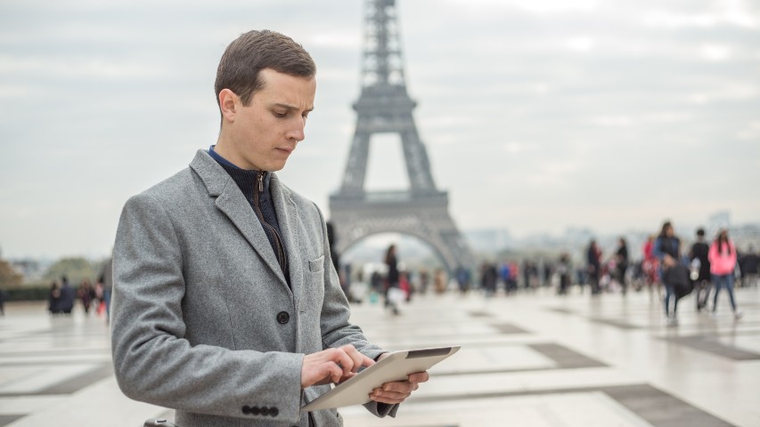 online services near syracuse ny image of uchoose rewards man on tablet infront of the eiffel tower