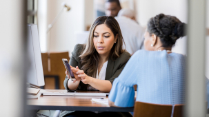 about our syracuse credit union employee showing phone to member