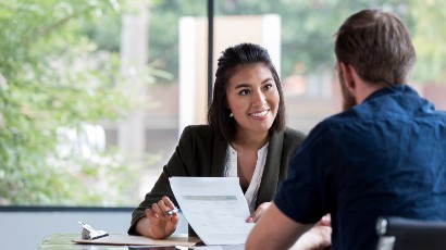 insurance products and services near syracuse ny panel image of a secny fcu employee talking to a client 