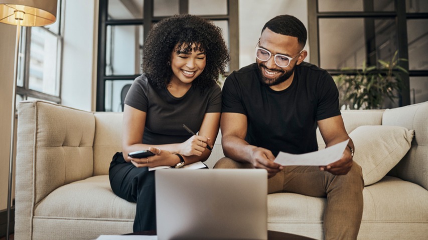 personal loans near syracuse ny couple looking at numbers and laptop