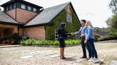 First Time Homebuyer near syracuse ny panel image for mortgages people shaking hands with realtor outside new home