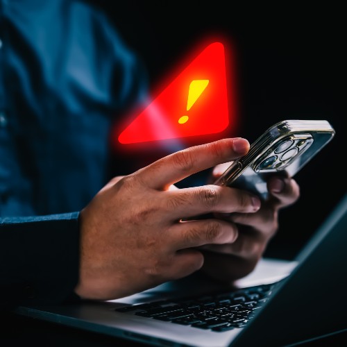 news and events near syracuse ny thumbnail image of man checking scam notification with red and yellow alert triangle on phone