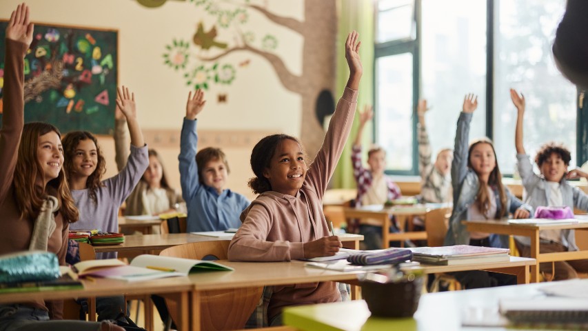 back to school near syracuse ny image of best credit union from secny fcu students with hands raised in school setting