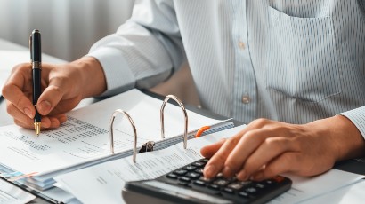 estatements near syracuse ny image thumbnail image of man working with a calculator at home from secny fcu