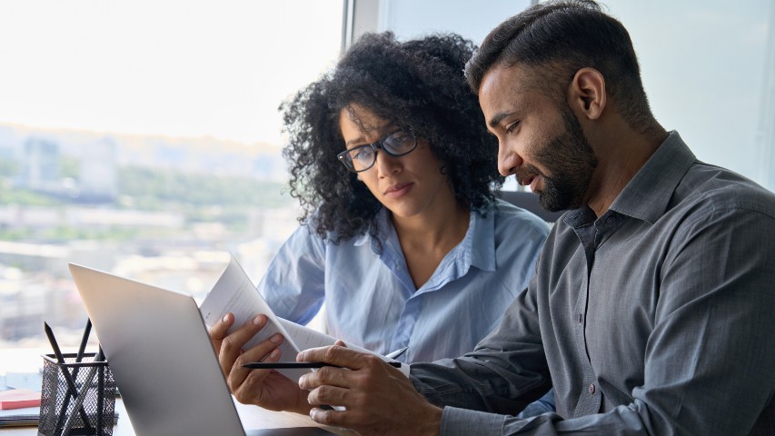 difference between a credit union and a bank near syracuse ny image of business banking online with secny fcu couple looking over papers on computer